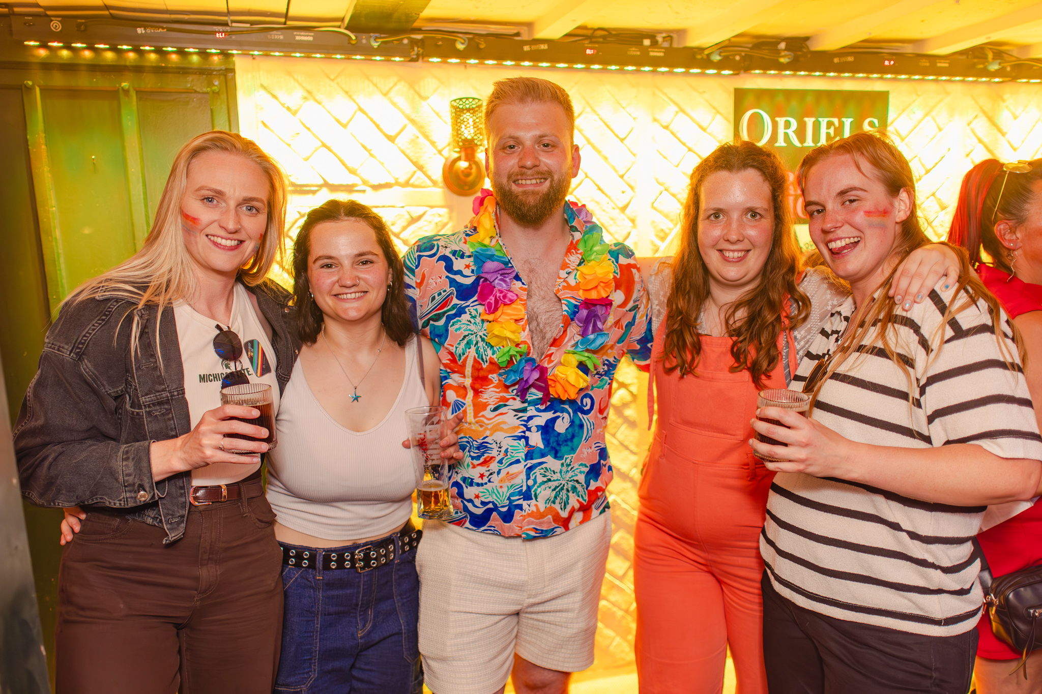 Friends raising cocktails at Oriels