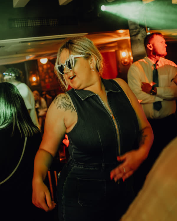 Guest in sunglasses dancing at Oriels Exeter