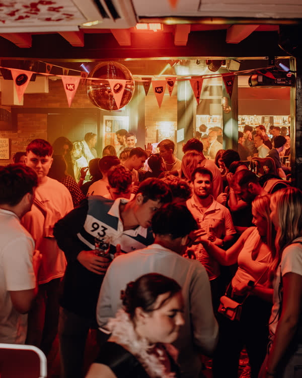 Packed dance floor under the bunting at Oriels Exeter
